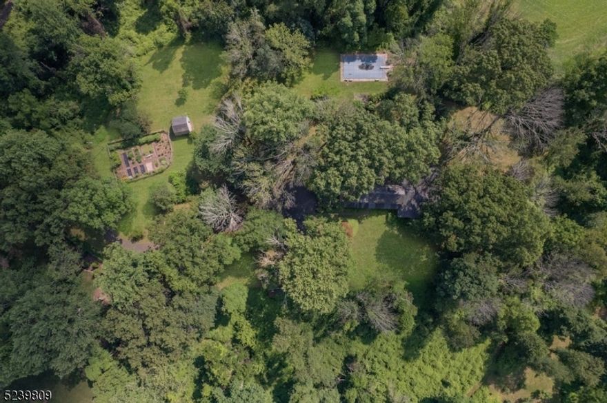 Tucked away down a long private drive, this flag lot features seven pristine acres in a park-like setting with mature specimen trees, a beautiful manicured sun-dappled lawn and level land.  A perfect opportunity to renovate the current structure or completely rebuild while taking advantage of existing utilities. Located in the heart of desirable New Vernon, this is the perfect opportunity to build your dream home in peaceful, bucolic Harding Township- just minutes from vibrant downtown Morristown and the midtown direct.