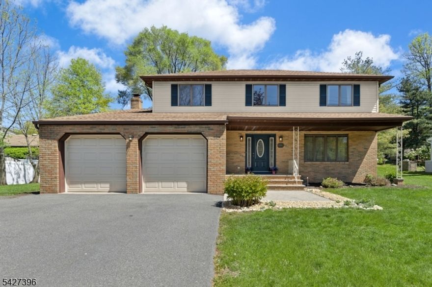 Spacious & well-maintained colonial offers flexible living & a beautiful, park-like setting. A welcoming entry foyer opens to a formal living room & dining room, where large windows frame views of the picturesque park-like backyard with flowering trees. The eat-in kitchen features Corian countertops, a breakfast bar, & a separate dining area with sliders to an expansive deck, perfect for entertaining! The first-floor family room is filled with natural light & offers a comfortable gathering space. This level also includes a convenient laundry area, powder room with updated vanity, additional storage & access to the garage. Upstairs, four generously sized bedrooms include a primary suite with walk-in closet, private bath with walk-in shower, & a versatile nook ideal for a home office. Three additional bedrooms offer double closets; both full baths have updated vanities with ample storage. Two linen closets provide added convenience.  An expansive unfinished basement with 8' ceilings offers exciting potential for a future entertaining hub, with a French drain and sump pump. The two-car oversized garage has side yard access & an extra wide driveway accommodating multiple vehicles. Major updates include central air, heat, and hot water heater, and roof. Set within a wonderful community, just a short distance to Coles Elementary and Terrill Middle School, and close to the Fanwood train station. Enjoy nearby Fanwood's vibrant downtown with its popular restaurants and charming shops!