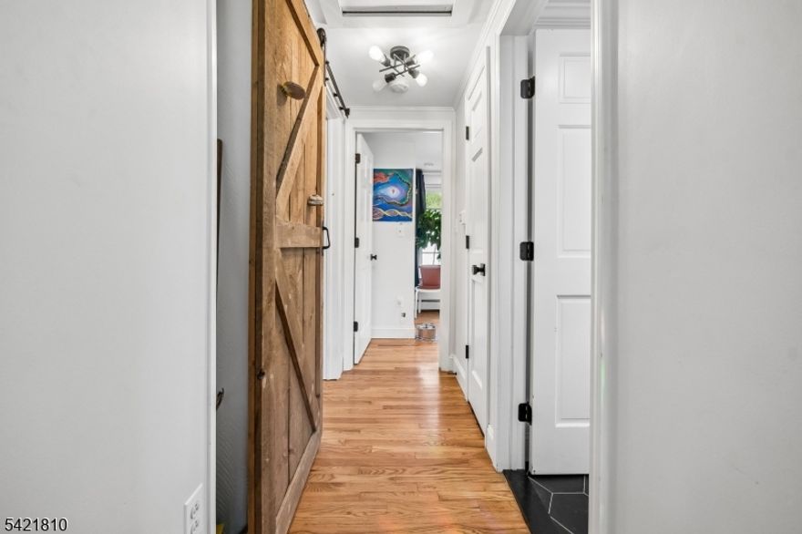 This charming two bedroom home sits on a spacious 0.34-acre lot with a fully fenced backyard ideal for pets, entertaining, or future outdoor projects. Located a mere STEPS from the Columbia Trail, enjoy easy access to scenic walking, biking, and nature. Inside, you'll find a bright and inviting layout with updated finishes, including beautiful hardwood floors and a renovated bathroom featuring modern fixtures and a clean, contemporary design. Natural light fills the living spaces, creating a warm and welcoming atmosphere.  Updated kitchen with breakfast bar. The septic system is NEW (two years old) and updated to two 1500 gallon tanks- one water and one solid waste- offering potential for future expansion. Laundry is conveniently located in the basement, along with extra storage space and utilities. Pull down attic. Outside, a large driveway provides ample parking for multiple vehicles, and a storage shed adds extra utility. Patio and shed complete the backyard. A great opportunity to own a home with character, updates, and room to grow in a desirable location.  Unlimited outdoor activities nearby such as Raritan River, Columbia Trail, Voorhees State Park. Many valuable items included in the sale of the home, such as some furniture and furnishings, shed, fire pit, smoker, grill, lawn mower, etc.  See complete list of inclusions and exclusions. Home being sold AS IS.