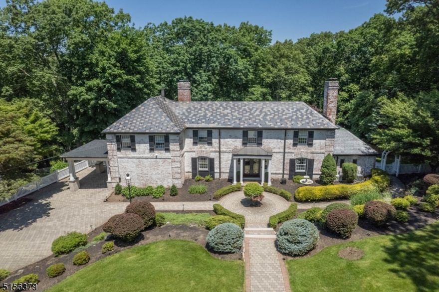 A masterful French-Style Estate tucked away on nearly an acre of luxurious grounds. This timeless white-wash brick 4BR 3.5BA colonial is ideally located in the Borough of Essex Fells & provides an entirely unique living experience. Sitting prominently far back from the street this move-in ready home offers privacy & a classically designed renovation with no detailed spared. Exuding warmth & sophistication throughout this home delivers the highest level of craftsmanship & refined millwork. Notable features include a gourmet chef's kitchen with center island, sunken family room with newly lined gas fireplace, two-story exposed brick wall & French doors that open to an upper patio with a full outdoor kitchen/entertainment space. The Dining room includes herringbone flooring & elegant wall trim located directly off the kitchen. Formal Livingroom consists of a double-sided fireplace overlooking the patio & yard. In addition, this home includes a full gym with double doors that open to a lower-level yard & media room that consists of a custom 180 bottle wine cabinet & wet bar. Outdoor areas resemble English gardens & have elegance to match the rest of the home with new diamond cut bluestone walkways & gazebo. Exterior features include slate roof, full home generator, landscape lighting, underground sprinkler system, commercial grade security system & a new custom porte-cochere. All fixtures & window treatments included. Furniture available for additional negotiated price.