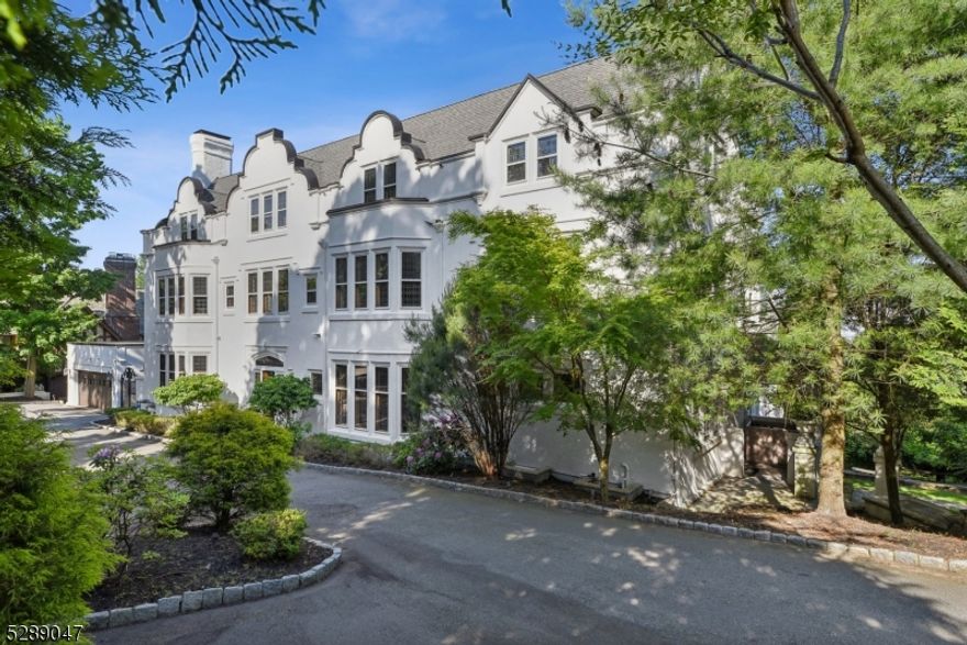 Elegant and beautifully built in 1912 this perfectly updated manor house overlooks the NYC skyline.  Incredibly spacious with gorgeous architectural details, 9 fireplaces, and leaded glass windows throughout.  Terrific renovated eat-in-kitchen with pantry is just off a family room and lavish formal dining room.  Lofty ceilings throughout.  Dramatic living room plus library/office on the first floor.  Nine sunny bedrooms with eight baths on the top two floors.  Finished lower level with a cinema room, bedroom suite, playroom, media, and storage.  Four car garage completely newly built.  Situated on over an acre of lovely landscaped, tiered very private property with an expansive terrace. Set on a charming cobblestone street in one of Montclair's premier locations, this is a uniquely special home for the ages!