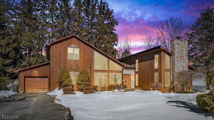 This exceptional South facing 4 bdrm, 3 bath contemporary residence is tucked away on a peaceful cul-de-sac, offering a perfect blend of style, and comfort. A wraparound driveway leads to a welcoming entry foyer that sets the tone once you step inside. The home has been thoughtfully updated with brand-new hardwood floors, new interior doors, fresh paint, new recessed lighting, new furnace and hvac system. The expansive family room is filled with natural light from floor to ceiling windows and skylights, anchored by a stone fireplace that creates a warm atmosphere. Just off this space, you'll find a convenient first-floor bdrm and full bath. The main living room showcases cathedral ceilings and an additional fireplace, flowing seamlessly into a sunken formal dining area designed for intimate dinners and gatherings. The adjacent kitchen is thoughtfully appointed with stainless steel appliances, custom cabinetry, dual wall ovens, a center island cooktop, and granite countertops. The first floor primary suite offers privacy and comfort, complete with a seated vanity, glass enclosed shower, and a relaxing jacuzzi tub. Upstairs, two generously sized bedrooms share a full bathroom with a storage vanity and glass enclosed shower. Outside, the spacious backyard serves as your own oasis with a large deck and jacuzzi, perfect for entertaining, or simply unwinding. The fenced in yard offers plenty of room for outdoor enjoyment. Conveniently located near Whole Foods, Lidl, and NJ transit!