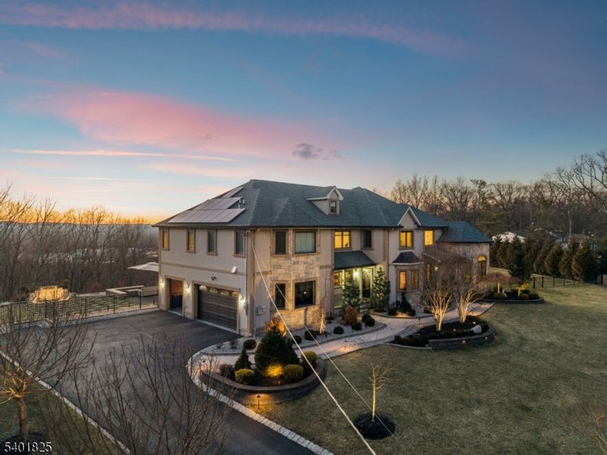 This impressive custom-built home offers 6 bedrooms, 5 full bathrooms, and 1 half bath, thoughtfully designed with spacious living areas and elegant architectural details throughout. A dramatic two-story foyer and living room with soaring vaulted ceilings create a grand entrance, filling the home with natural light and offering a beautiful sense of openness. The main level features a formal living room, dining room, private home office, and a spacious family room that flows seamlessly into the large eat-in kitchen, creating the perfect open-concept space for everyday living and entertaining. The custom eat-in kitchen is equipped with high-end appliances, abundant cabinetry, and generous dining space, making it the true heart of the home. A first-floor bedroom and full bath provide excellent flexibility for guests, or a private guest suite. Upstairs, the luxurious primary suite offers a private retreat with two walk-in closets, a spacious bath, and a private balcony with stunning views through oversized windows. The open upstairs hallway overlooks the living room below, enhancing the home's grand and airy feel. The fully finished walk-out basement expands the living space with exceptional amenities including a home theater, gym, bedroom, full bath, custom bar, and recreation room, ideal for entertaining or relaxing. With its generous layout, 9 foot ceilings, custom features, and beautiful views, this home offers a perfect blend of comfort, elegance, and functionality.