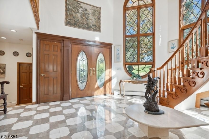 Elegant & picturesque home on the Ramapo River! Spacious Colonial/Tudor home offers riverfront views, a guest house, horse stable, screened-in gazebo & so much more. Situated on over 2.5 ac of private property, this home is close to well-regarded schools, the train station & a nearby skiing + snowboarding slope. The beautifully landscaped front entry welcomes you into a light-filled interior with hardwood floors, large, round-topped windows & elegant crown molding. The 2-story foyer with a curved staircase flows to a formal dining room & a spacious living room with a fireplace and floor-to-ceiling windows. French doors open to a temperature-controlled atrium with panoramic views of the surrounding natural beauty. The bright kitchen features stainless SS appliances, walk-in pantry & large center island. A beautiful, round-topped door in the breakfast area opens to the spectacularly terraced back yard " the perfect setting for watching the seasons change. A back staircase & a powder room complete the main level.The second floor offers a luxurious primary bedroom with plenty of closet space, sliding glass doors to a balcony & a sparkling en-suite bath with a skylight, soaking tub & glass shower. This level includes a large, sunny family room & 2 additional bedrooms, each with their own en-suite bathrooms, one with a private sunroom & one with access to the balcony. The partially finished basement offers a 1,000-bottle wine cellar, rec-room, laundry area & abundant storage.