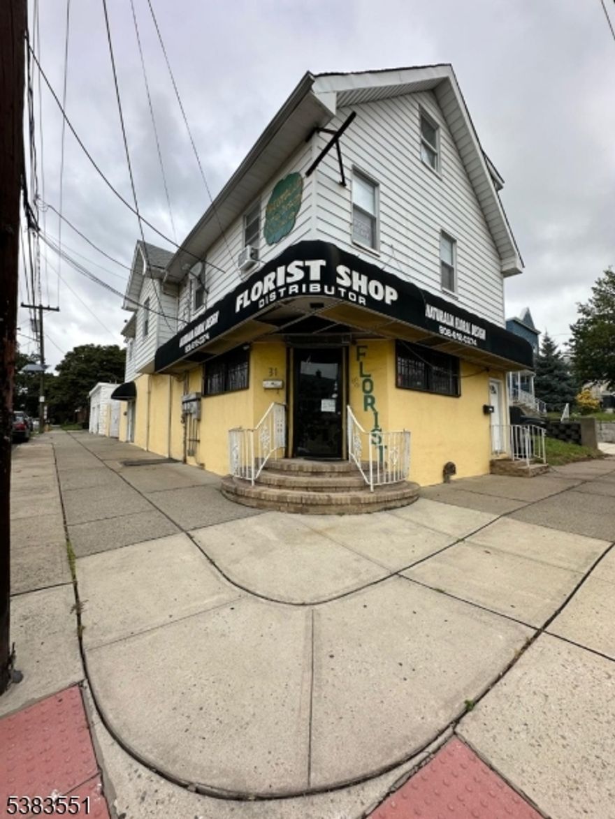 Building with one commercial space first floor using  as a Flower Shop (sell separate $90,000) and 2 duplex apartment with 3 beds and 2 bath each apartment. This is a corner building doble lot