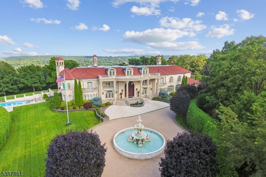 This European masterpiece, a true French Chateau, offers unparalleled beauty and with 14,000 sq ft ideally located on 3.8 acres of meticulously landscaped property at the end of a cul de sac with incredible privacy and spectacular panoramic views of the iconic New York City skyline. Nestled atop one of the highest points in Essex County. Custom built to perfection, this 4-story residence features top of the line resort-like amenities including a heated, gunite pool and spa, a relaxing sun deck, tranquil meditation garden with koi pond, multi-purpose sports court perfect for tennis or basketball and a spectacular home gym with sauna and steam room. Inside this magnificent residence there is a luxurious Master Suite with 2 spa-like baths & 2 custom walk-in closets & private state of the art movie theater, billiards, sports area with media and a stunning pub imported from Europe with leaded and stained glass windows. There is a private balcony with exclusive views of the New York City skyline. This architectural gem, located only 17 miles from New York City, features a limestone exterior, 3 levels of balconies and a grand entrance hall with a double bridal staircase and gilded railing imported from Europe. With tremendous privacy, 8 bedrooms, 9.3 baths, 6 gas fireplaces and French doors throughout the home, opening to front and back verandas on 3 levels, this home is sure to amaze. Your own private oasis! One of the most extraordinary estates in the NY Metropolitan area!