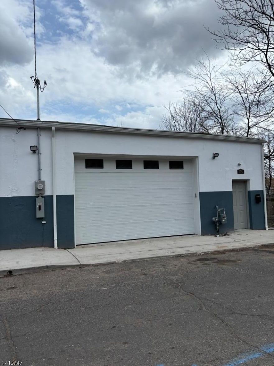 Fully renovated commercial garage . Around 1,900 gross SqFt. Brick on all 4 sides, 10 ft automatic overhead garage door and 14 ft high interior ceilings. Private office space, half bath, utility room with slop sink, and kitchenette. Everything is brand new: roof, doors, electrical, plumbing, and heating. New water line and  sewer. New gas lines and  200 amp electrical service. Everything is brand new. Ideal for small  contractors and those needing warehousing and storage space.