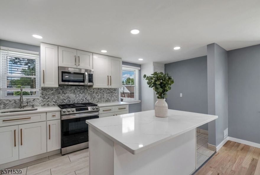 Look no further. This beautifully renovated 2-bedroom, 1-bath second-floor unit exudes modern elegance and comfort. As you step inside, you'll be greeted by brand new hardwood floors that flow seamlessly throughout the space. The heart of the home, a stunning new kitchen, boasts luxurious quartz countertops, a spacious center island perfect for meal prep or casual dining, and sleek cabinetry that provides ample storage. The updated bathroom features contemporary finishes, ensuring a relaxing retreat. Situated in a prime location, this unit offers the convenience of being close to public transportation and vibrant downtown shops, making it perfect for both commuting and leisure. Don't miss the opportunity to make this exquisite rental property your new home!