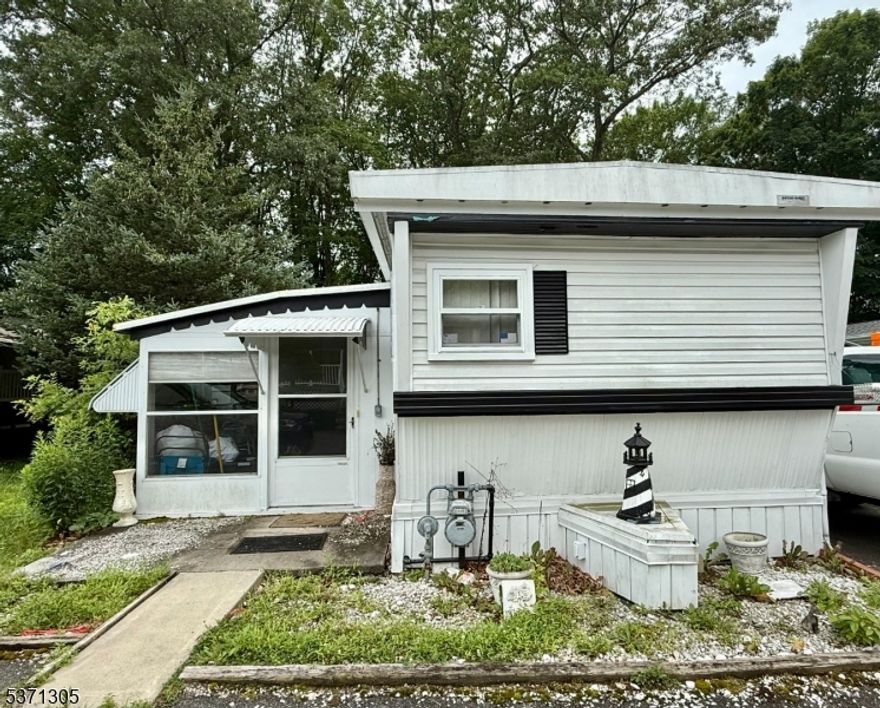 Hoffman Mobile Home for sale in a beautiful, quiet community near Rockaway Mall and easy access to Rt 80! This 2-bedroom, 1 full bath Ranch home features an eat-in kitchen, a spacious living, 2 bedrooms, bath with stackable laundry and am oversized sunroom. Tons of potential!! Storage shed & carport with driveway.