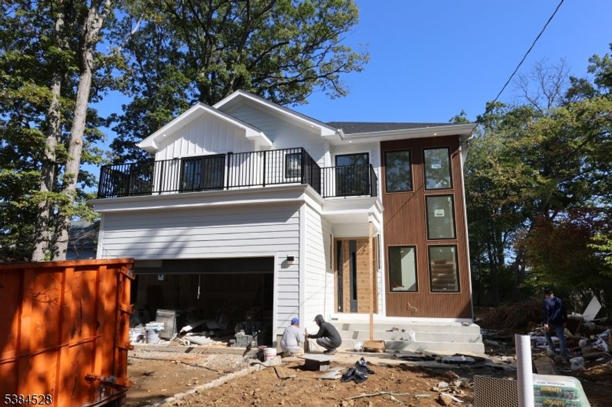 Perfectly located in a desirable neighborhood, this beautifully crafted residence offers approximately 3,250 sq. ft. of thoughtfully designed living space, blending modern luxury with everyday convenience. Featuring 6 spacious bedrooms, 5 full bathrooms, and a stylish powder room, the home welcomes you with a dramatic two-story foyer and an open layout designed for both comfort and style. The sun-filled, two-story great room provides an inviting atmosphere, while the gourmet kitchen complete with premium Thermador appliances connects seamlessly to the mudroom and two-car garage. A first-floor ensuite adds versatility, ideal for a home office, or guests. Upstairs, the primary suite offers a retreat-like experience with a custom walk-in closet and spa-inspired bathroom. This level also includes a vaulted-ceiling ensuite bedroom, two additional bedrooms, a full bathroom, and a convenient laundry room. The walk-up lower level expands the living space with a gym, media room, recreation area with wet bar, plus an additional bedroom and full bathroom, making it perfect for a variety of lifestyle needs. Every detail has been carefully designed to enhance comfort and functionality. All square footage is approximate. Includes a 10-Year Builder Warranty.