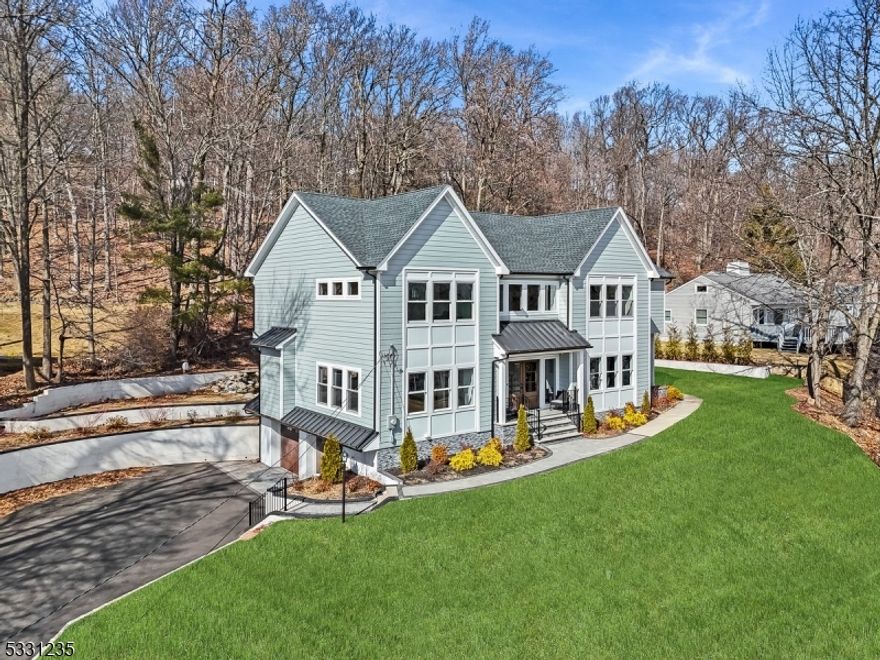 Center hall colonial newly built from the ground up in the heart of Mountainside. This turnkey 5 bd, 4 bth home sits on a private half acre lot. Be wowed upon entering by the grand foyer's soaring ceilings. The bright and airy open floor plan blends living, dining & entertaining areas with a well-defined formal dining room, while a wall of windows fills the space with natural light. The family room, with a sleek linear gas fireplace, flows into the gourmet kitchen featuring a quartz waterfall island, custom cabinetry, Sub Zero fridge, Wolf appliances, farmhouse sink, built in microwave, wine fridge & sliders to the deck and paver patio for dining al fresco. The 1st floor offers a butler's pantry, versatile guest room & chic full bath. Upstairs, the spacious primary suite stuns with a tray ceiling, outfitted walk in closet & spa like bath w/ dual sinks, soaking tub & large shower w/ decorative tile & rain shower. 3 additional bedrooms include an ensuite & Jack & Jill bath, all w/ walk in closets & a 2nd floor laundry. The finished lower level offers a rec room & private office. Gleaming hardwood floors, Hunter Douglas motorized blinds throughout, Lutron dimming remote light switches & nest thermostats. 3 car garage provides ample parking. Close to top rated schools, easy NYC commute, shops & dining.