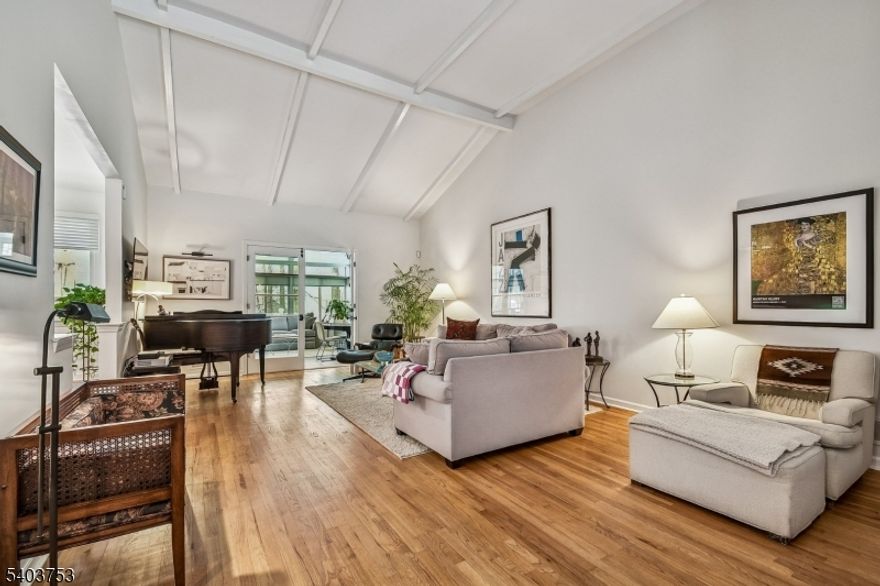 LOCATION!! LOCATION!!  Perfectly nestled on just under an acre in a coveted double cul-de-sac neighborhood, this beautifully maintained CUSTOM raised ranch combines thoughtful design with seamless indoor-outdoor living. A welcoming foyer opens to a sun filled living room featuring vaulted ceilings and a classic wood burning fireplace, creating a warm gathering space. The adjoining newly added sunroom overlooks the wooded backyard and provides access to a spacious deck for all year round living. The main floor centers around a well equipped kitchen with double ovens, a cozy breakfast area and an adjacent formal dining room. The primary suite features a renovated full bathroom and generous closet space. Three additional bedrooms share a full hall bath, and a convenient powder room completes the level. The walkout lower level offers exceptional versatility, featuring a family room and a recreation room with its own wood burning fireplace. This level also includes an additional bedroom with a laundry area, a convenient powder room and direct access to the patio and two car attached garage. With excellent curb appeal, flexible living spaces, and a serene setting, this home presents a wonderful opportunity for comfortable everyday living and entertaining alike.