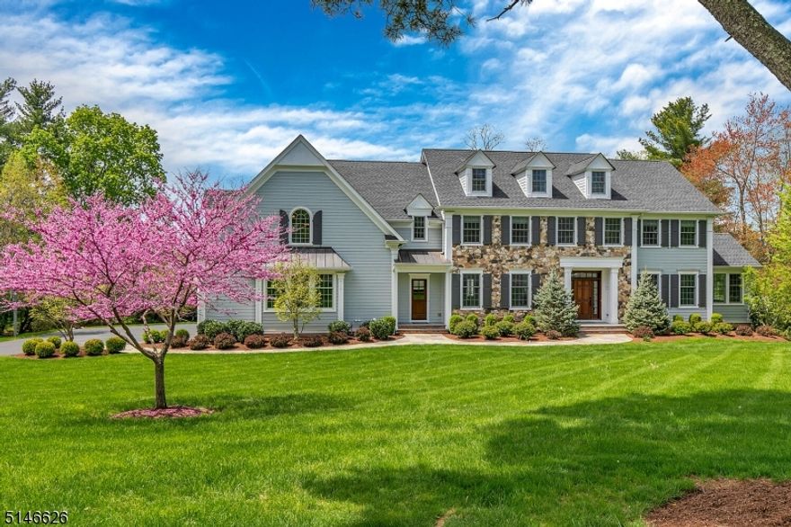 We are proud to present the newest entrant to our Global Luxury portfolio. This stunning 5 BR, 5.1 bath center hall colonial is beautifully appointed and situated on a tranquil .92 acre, in Basking Ridge, in a neighborhood of sweeping lawns and mature trees. The 2-story foyer previews the design elements found throughout the home - crown molding, wainscot, coffered ceiling, hardwood floors and a floorplan that is perfect for both entertaining or simply relaxing with friends. On the 1st level there are formal living & dining rooms, butler's pantry, conservatory, private office as a work from home retreat, and a family room with fireplace, open to the kitchen. The impressive, chef-designed kitchen is the heart of the home, with furniture quality cabinetry, granite counters, center island, professional grade SS appliances, 48" Sub-Zero Refrigerator, Wolf range, exhaust hood & a dining area that opens to the deck. Upstairs, the spa-quality primary suite, has 2 walk-in closets, volume ceiling, soaking tub, walk-in frameless shower, water closet & 2 vanities. There are 4 additional bedrooms - 2 ensuite - and a well-appointed shared, full bath. The walk-out finished basement is a true 3rd level of living space with a wet bar, wine cooler, dishwasher and full bath. The rec room is a great space for gatherings, working out, or enjoying movies. This home is in close proximity to nationally ranked schools, transportation, highways, shopping, and dining. All this plus a central location!