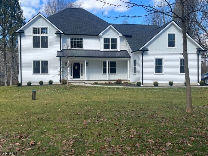 Introducing a stunning new construction home offering over 4,000 square feet of thoughtfully designed living space. This exceptional residence features 4 bedrooms and 3.5 baths, set on a picturesque one-acre lot just minutes from downtown Chester.A dramatic two-story foyer welcomes you into an open, light-filled floor plan highlighted by soaring ceilings and elegant wide-plank hardwood floors throughout. The chef's kitchen is a true showpiece, featuring a large center island with Calacatta countertops and top-of-the-line Thermador appliances. The space flows seamlessly into a sunlit eat-in area and an inviting family room with a cathedral ceiling and a cozy gas fireplace. Step out onto the deck off the kitchen perfect for outdoor dining and entertaining. Just off the foyer, a private study or home office with French doors provides an ideal work-from-home space. Upstairs, the expansive primary suite offers a walk-in closet and a spa-like bath with double vanities, a soaking tub, a stall shower, and elegant Elysian Gold countertops. Three additional bedrooms include one with an ensuite bath, along with a generous bonus room ideal for a game room, media space, or recreation area. Designer lighting from Chester Lighting enhances the home's sophisticated ambiance. Additional highlights include a heated three-car garage equipped with an electric vehicle charger. This exceptional property combines luxury, comfort, and modern convenience and is truly a must-see.