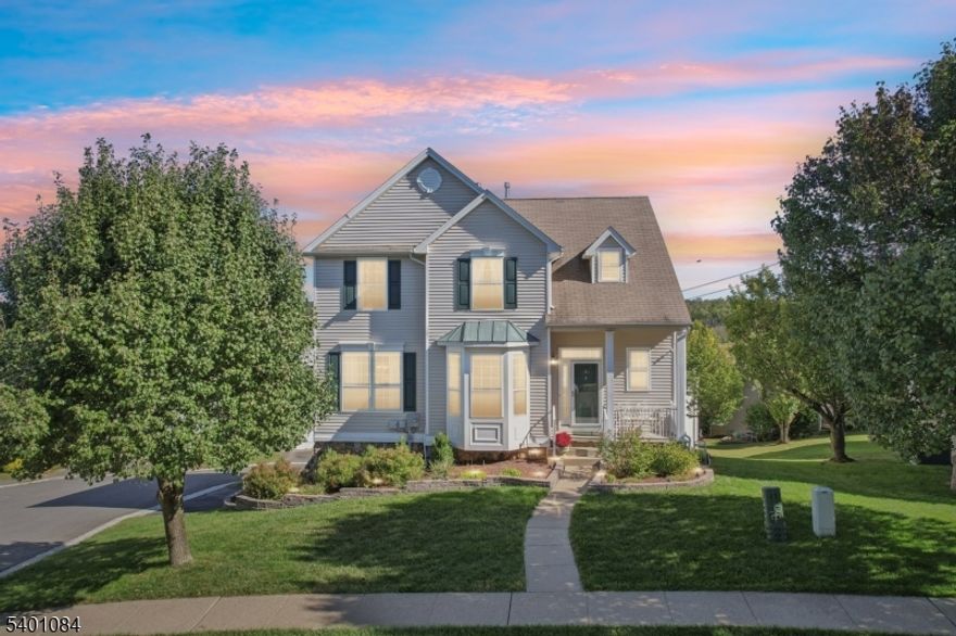 This 3-bedroom, 2.5-bath colonial lives like a 4-bedroom thanks to its fully finished above-ground basement, with potential to easily add a 4th bedroom. Welcome to Woodfield Estates, where community comes alive! Picture afternoons by the sparkling pool and evenings where neighbors become friends on the sports courts and ball field. This sun-drenched 2000-built Ashwood model wraps you in modern comfort with soaring ceilings and light-filled open spaces perfect for gathering. The heart of the home is a magazine-worthy kitchen with center island that would make any design enthusiast or cooking enthusiast swoon. It flows seamlessly to your private deck where coffee tastes better and summer evenings linger longer with amazing views of the rolling hills in the distance. Rich hardwood floors shine throughout the main level, leading to a serene primary suite featuring a tray ceiling and spa-inspired updated bathroom retreat and two generous walk-in closets. Mt. Olive's high rated Morris County schools serve the community, while your two-car garage, natural gas heat, and central air provide effortless living. The bright above-ground basement expands your possibilities for an additional bedroom, fitness room, home office, or cozy entertainment space. This move-in ready home in sought-after Mt. Olive blends suburban tranquility with easy highway access for wherever life takes you. Shopping and dining await minutes away, yet home feels like your own peaceful escape.