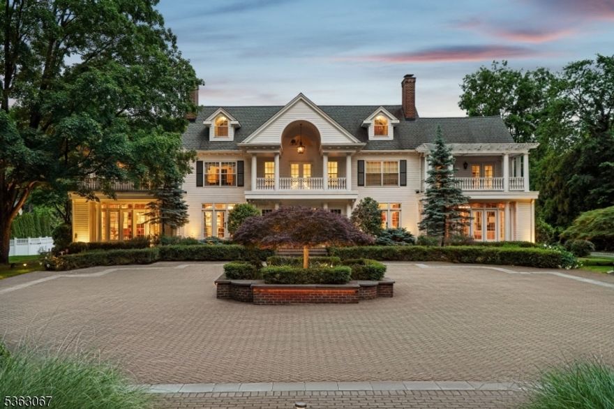 Tucked behind the gates of prestigious Llewellyn Park, this distinguished estate blends timeless elegance with modern luxury on nearly 2 acres. Rebuilt from the foundation in the 1990s and beautifully renovated in 2022, the 6-bedroom, 8.3-bath residence spans five levels with elevator access. A grand staircase and soaring ceilings lead to herringbone wood floors, arched doorways, and sun-drenched living spaces. The formal living room with a marble fireplace opens to a sun-drenched sitting room, while a character-rich office with a spiral staircase offers direct access to the primary suite above. The banquet-sized dining room, adorned with a Carrara marble fireplace and Murano-style chandelier, flows into the chef's kitchen featuring radiant heated floors, top-tier appliances, and a bright breakfast area. Upstairs, the expansive primary suite is a private haven with dual spa baths, two walk-in closets, a dressing room, gym, coffee bar, and a serene balcony. A separate level holds a recreation room with en-suite bath, sitting area, and storage. The finished basement includes a custom, soundproofed recording studio ideal for music, podcasting, or content creation. Outside, enjoy a heated infinity pool, spa, pergola with retractable awning and fireplace, sport court, and a separate 1-bed/1-bath Carriage House perfect for guests. Sq footage is approx*