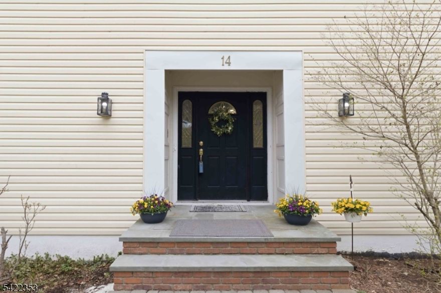 This 4-bedroom center hall colonial in one of Morris Plains most desirable neighborhoods offers the space, layout, and functionality that today's buyers are looking for.  The 1st floor creates an easy flow between living spaces, with sun-filled rooms of generous sizes. Living room, dining room, family room, convenient powder room and new kitchen complete the main level.  Eat-in kitchen with center island and a slider leading to a private deck, perfect for everyday living or entertaining. Interior has been freshly painted, giving the home a clean, move-in-ready feel while still offering the opportunity to make it your own over time. 2nd level boasts four spacious bedrooms, including a primary suite with a jetted tub and walk-in-closet along with the added bonus of a convenient second-floor laundry closet. The finished lower level with garage entry expands your living space with a full bath, patio access, and entry to an oversized two-car garage. A heated driveway, paver walkway, vinyl siding, and updated windows add to the home's strong curb appeal and overall convenience.   A home with great bones and endless potential in a prime location.