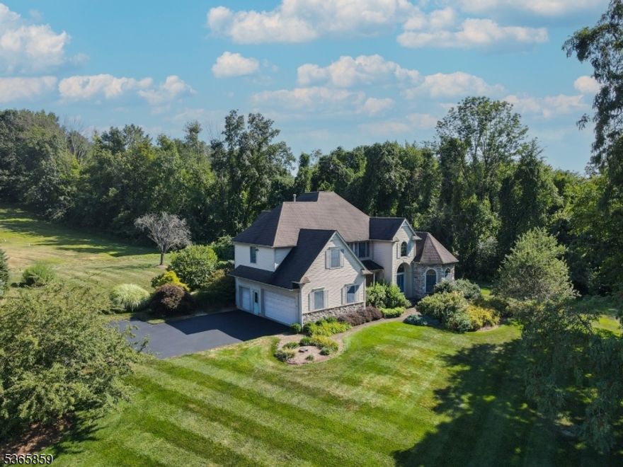 Welcome to the cornerstone of Balmoral! This stunning 4 bed (plus a bonus room), 3.2 bathroom custom colonial is on a private 1-acre corner lot in sought-after Balmoral Estates. As the first home built in the neighborhood, it sets the tone with 3,169 sq ft of timeless design and thoughtful upgrades throughout. A grand entrance welcomes you with soaring ceilings and a chandelier that lowers by chain. The vaulted first-floor primary suite features a walk-in closet and en-suite bath. Entertain in the kitchen with granite counters, center island, wine fridge, and close by is a wonderful fireplace to tie the whole setting together. Enjoy peaceful outdoor living with your own Macintosh apple tree. One of the bonus rooms is set up as a home theater perfect for movie nights. Each bedroom has its own full bath. Discover the spacious basement with 10 foot ceilings, massive attic, two-car attached garage, and 200-amp electric. Additional highlights include a whole-house generator, new water heater, home filtration system, natural gas, 6-zone underground irrigation, hot tub, level backyard, and an invisible dog fence. Just minutes from Crystal Springs Resort with world-class golf, 5-star dining, spas, and year-round recreation. Located in a quiet golf course community offering privacy and luxury.