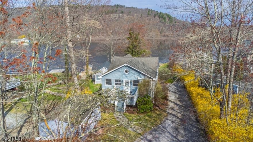 Gorgeous Lakefront home on the West Shore of Culver Lake set on a large, level, private lot with ample parking. This property offers year-round living with direct water access, a sandy beach area for wading, and western exposure providing incredible sunset views. The home features an updated kitchen with granite countertops, custom wood cabinetry, and stainless steel appliances. The dining area overlooks the lake and opens to an additional living space with a new pellet stove. A large utility room and full bath complete the lower level. The main level includes a living room with vaulted ceilings, two bedrooms with lake views, and an updated full bath. The upper level offers a loft suitable for office or flexible use, along with a third bedroom. Exterior highlights include a boathouse with electric and a water pump for irrigation, a large cantilever dock, and two large storage sheds. Additional features include a whole-house generator and furnace replaced in 2019. Located in the private 555-acre Culver Lake community, enjoy year-round access to boating, fishing, water skiing, kayaking, a clubhouse, beach, and canteen. Conveniently located approximately one hour from NYC. New 3 bedroom septic will be installed before closing.