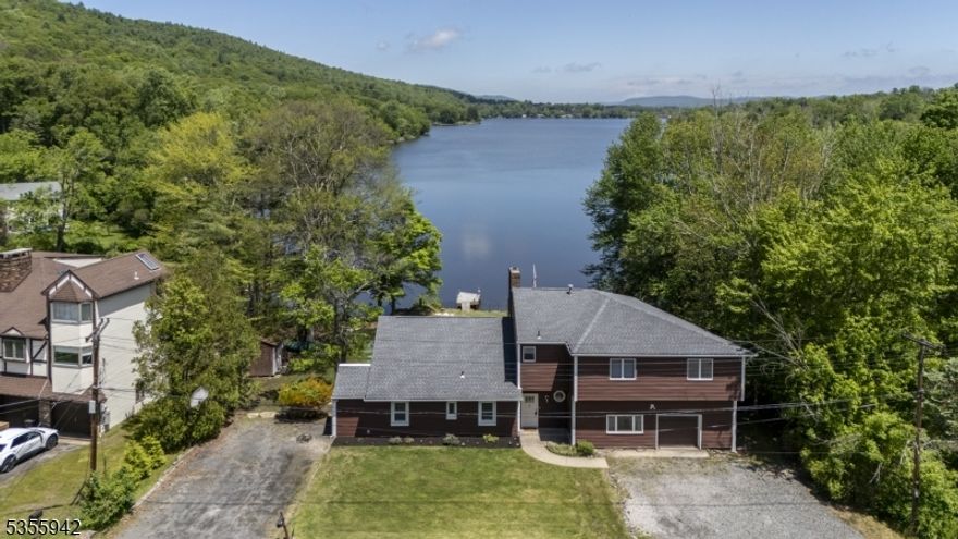 Beautiful lakefront home nestled in the Stowaway section of Pinecliff Lake- 10 rooms including 4 bedrooms & 3 full baths perfectly designed for comfortable living and entertaining. The master suite features a private deck with stunning views of Pinecliff Lake & Bearfort Mountains. Recent updates include new siding, roofing, flooring on both levels, many windows, Boiler, hot water heater and 4BR septic in 2023. Modern kitchen features new S/S appliances new floors and new counter top. Great room impresses with beam ceiling and wall of windows overlooking the lake. Family room, two dens/offices and so much more. Set on a 1/3 acre level lakefront property offering direct access to water and serene outdoor living with the perfect blend of privacy, comfort and natural beauty. Septic is only 2 years old, tanks being replaced now with engineering and town permits- Home is IN good standing with Pinecliff lake and Stowaway Park