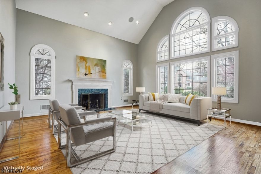 This stately brick Colonial set on a coveted cul-de-sac in the prestigious Hill section of Madison boast soaring ceilings, Palladium windows, two story foyer and great open floor plan. Sure to please any chef the large gourmet kitchen is thoughtfully designed with custom cabinetry, Wolf ovens, subzero fridge and is open to a breakfast room and family room. The family room boasts a wall of built ins, wood burning fireplace and door to Trex deck. Off the family room is a large living room with cathedral ceilings, gas fireplace and a Palladian window. An office, banquet size dining room, bedroom with en-suite bath, powder room and laundry room complete this first floor.  The second floor offers 3 en-suite bedrooms and the primary bedroom enjoys 3 walk-in closets, dressing room and en-suite bath.  The lower level has a recreation room, game room, large wine cellar for 3000 wine bottles, a half bath and plenty of storage.  A lovely patio with circular built in fire pit is the perfect space for al fresco dining, entertaining, and relaxing overlooking your private yard that is beautifully landscaped with specimen shrubbery, mature trees and Lutron lighting.   A three car garage with built in storage, paver driveway, beautiful walkways and so much more complete this lovely home.  Enjoy living in Madison rated #1 town to live by NJ Monthly