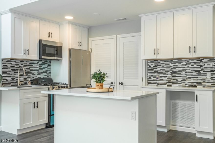 Welcome to this beautifully updated 2-bedroom, 1-bathroom condo, offering a blend of modern comforts and stylish design. Step inside to discover new flooring, providing a sleek and cohesive look to the entire space. The freshly painted walls add a bright and welcoming ambiance to every room. The condo boasts high ceilings, enhancing the spacious feel of the living areas. Recessed lighting throughout adds a touch of sophistication and ensures a well-lit environment. The gourmet kitchen is a chef's delight, complete with a central island that provides an eat-in experience and extra storage. The luxurious bathroom is a highlight, featuring a sleek LED mirror that adds both functionality and a contemporary touch. Step outside to your private deck, perfect for entertaining or enjoying a relaxing evening. Experience the perfect combination of elegance and functionality in this meticulously updated condo. Additionally, featuring brand new appliances including washer/dryer, haier refrigerator, oven range, and microwave. Move right in!