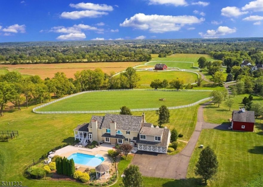 Venture into a realm of elegance and grandeur at Chestnut Hill Farm, an exquisite colonial estate nestled amidst the rustic allure of Hunterdon County. Enveloped by 300+ protected acres of prestigious farmland, this property offers mature surroundings, exceptional equestrian amenities, and unparalleled improvements. Whether you seek privacy, have a passion for horses, or are searching for the perfect sanctuary outside the city, this property offers it all. Turn down the long & fully private drive, and behold the invigorating atmosphere that radiates beauty from every vantage point. This turn-key address ensures visual delight, as well as operational efficiency. The pristine, 25+ acres parcel is inclusive of an iconic 5-stall horse barn built by B&D builder, a detached garage studio with a loft and heated workshop, 2 solar panel arrays, entry way to the Amwell Valley Trail System which offers direct access to 30+ miles of trails for biking, hiking, horseback riding, and cross-country skiing. If you've been looking for a property with equestrian accommodations as well as modern updates then you have met your match at Chestnut Hill Farm.  Conveniently located only 80 minutes from NYC.