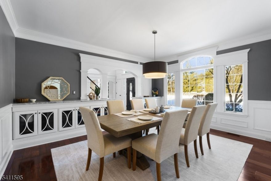 Situated on a private cul-de-sac, this stunning home delivers the perfect blend of timeless elegance & luxury. The chef's kitchen is the true heart of the home, anchored by a massive quartzite center island & outfitted with a 48  Wolf range, brand new bosch dishwasher, warming drawer, ice maker, temp controlled wine cellar, bar area, and sun-filled breakfast room. Custom inset cabinetry, thoughtfully designed pantry storage & a cozy sitting area w/ a sleek gas fireplace. The dramatic two-story fam room is a showstopper w/ soaring vaulted ceilings, intricate architectural millwork, a statement brick fireplace, sweeping rear staircase, & multiple French doors opening to the yard. Outside, your private resort awaits: a bluestone patio, wood-burning fireplace, heated saltwater pool w/ cascading waterfalls, raised chef's garden, covered lounge area & manicured lawn. Car enthusiasts & organizers will appreciate the 3 car garage makeover w/ custom cabinetry & extensive storage solutions w/ new epoxy flooring. Home also features a 1st floor office, designer mudroom, copper gutters, metal roof & 2 updated HVAC systems! The luxurious primary suite features a tray coffered ceiling, walk-in closets w/ custom built-ins and a spa-inspired bath w/ luxe shower, tub & heated floors. 3 additional BR's w/ custom closets, 2 full baths & a convenient laundry room complete the SL. The finished LL offers exceptional bonus space w/ a large recreation room, full bath, gym & a speakeasy-style pub.