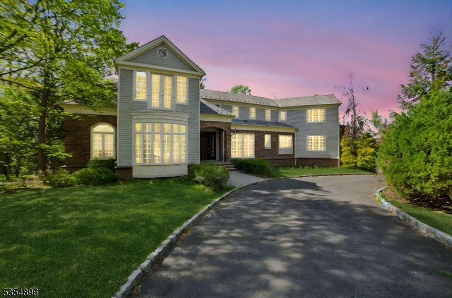 This elegant custom home was renovated in 2014 and 2025 with a seamless mix of luxury and modern convenience, as it was featured in the NJ Design magazine. The property boasts architectural elegance, high ceilings, long arches, crafted solid wood columns and doors. The renovated gourmet kitchen showcases the Jerusalem countertops, large center island, Wolf/Sub-Zero appliances, double Miele dishwashers and spacious custom pantry. The first floor also has a two-story family room with a floor-to-ceiling brick fireplace, spacious living room, office/library with a bar and a full wall of book/display shelves and a half bathroom. The laundry room and an in-law suite with a full bath complete the first floor. The master suite on second floor has two huge WIC/dressing rooms, a sitting area sharing a 2-sided marble gas fireplace with a luxurious master bath, and a French door open to the Juliette balcony. Another suite and two bedrooms with a shared bath compete the second floor. The huge deck can be accessed from the family room and the living room, equipped with an outdoor kitchen with a Viking grill. The fully finished basement is ideal for recreation and entertainment with walkout to the private backyard backing up to Green Acres. The whole house has Lutron lighting system. Mins away from Pingry School and easy access to major highways.