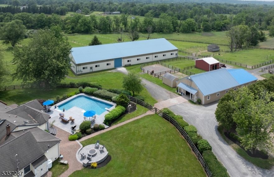 Thoughtfully designed with attention to detail, this equestrian facility can accommodate the serious amateur or professionals' needs. This beautiful turn key facility is sited on almost 11 acres nestled in 'the valley' which is home to the Amwell Valley Hounds Hunt and Amwell Valley Trail System! A long tree lined private drive brings you to a private oasis featuring a cottage style home which has been updated to today's standards. A wonderful country kitchen, which is the heart of the home, features walls of windows overlooking the salt water pool & farm! Open floor plan with high ceiling family room with fireplace. Formal dining & living rooms provide a cozy contrast. Primary suite opens to deck & pool. Two other generous bedrooms are serviced by a full updated bath. The utility wing has powder room, laundry & ample closet storage. The center aisle barn has 10 box stalls, hot & cold water, wash stall, tack & feed room & full loft, Wifi, fire alarm system & blue tooth capabilities for sound system. A bright and airy 180'x80'  indoor arena features GGT footing, LED lighting, sound system, heated viewing room. There is an outdoor arena 200'x80' with sand footing & gazebo for viewing opportunities. A European hot walker is tucked away with easy accessibility to paddocks & lush fields which have automatic waterers. Located near "all things equestrian", top vets, easy access to NJ & PA HORSE PARKS, POLO, Horse shows, Fox hunting, trails, hunter paces, tack and feed shops.