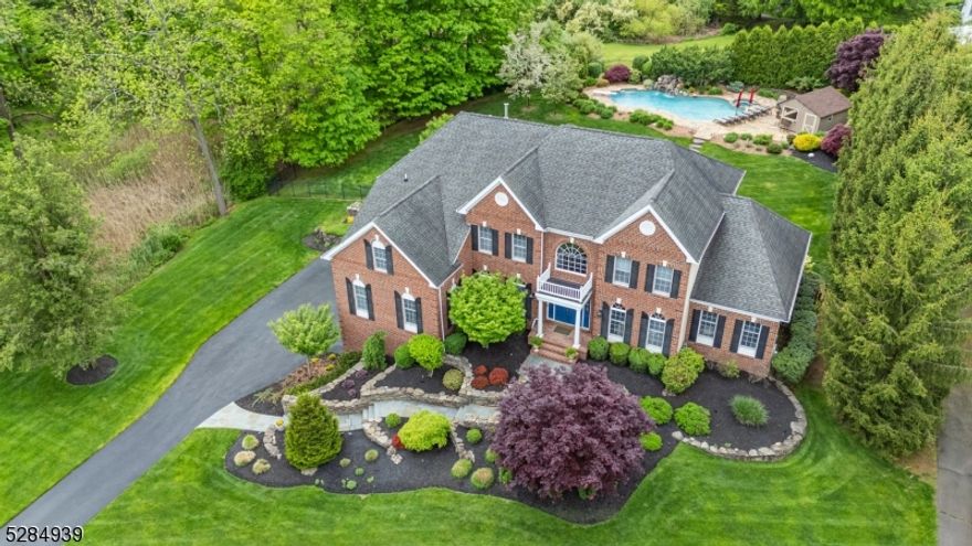 Enjoy luxury living in one of Bernards Twp's most desirable neighborhoods, Canterbury Estates. This classic brick colonial is set on an extraordinary property that embodies resort-like tranquility. A generous pool w/cascading waterfall and charming cabana is surrounded by lush landscaping and vibrant plantings, creating a private, picturesque oasis.  This inviting home features a 2-story foyer, recently fin hardwood flrs, detailed millwork and a layout perfect for entertaining.  The updated kitchen is a culinary paradise, w/white and gray cabinetry, quartz countertops, spacious center island and SS appliances. Flowing effortlessly from the kitchen is a 2-story family rm, bathed in natural light streaming through a wall of windows. A generous 1st floor in-law suite includes a bdrm, living rm and bath. Elegant touches abound throughout the home, with a fabulous sunroom, handsome office, sophisticated living rm & formal dining rm offering both ambiance and refinement. Upstairs the primary suite features an expansive sitting rm, colossal walk-in closet and luxurious bath. The additional bedrooms on this level w/attached bths ensure ample space. The bsmnt level offers an outstanding gym and tons of space w/high ceilings throughout.With its blend of timeless charm and modern luxury, this exceptional residence offers a lifestyle of unparalleled comfort and sophistication. Incredible location is walking distance from Liberty Corner Elementary and a short distance to both 78 & 287