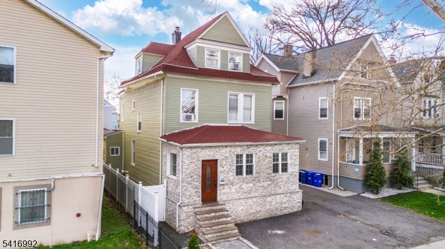 Spacious 5-bedroom, 2 full bathroom single-family home located in East Orange. This home offers a functional layout with generous living and dining areas and abundant natural light. The kitchen provides ample cabinet storage and workspace. Bedrooms are well-sized and offer flexible use.Finished basement and finished attic provide additional living space. Roof replaced in 2020. Off-street parking includes 2 front spaces and 3 rear spaces. Conveniently located near shopping, dining, parks, public transportation, and major highways with access to NYC.