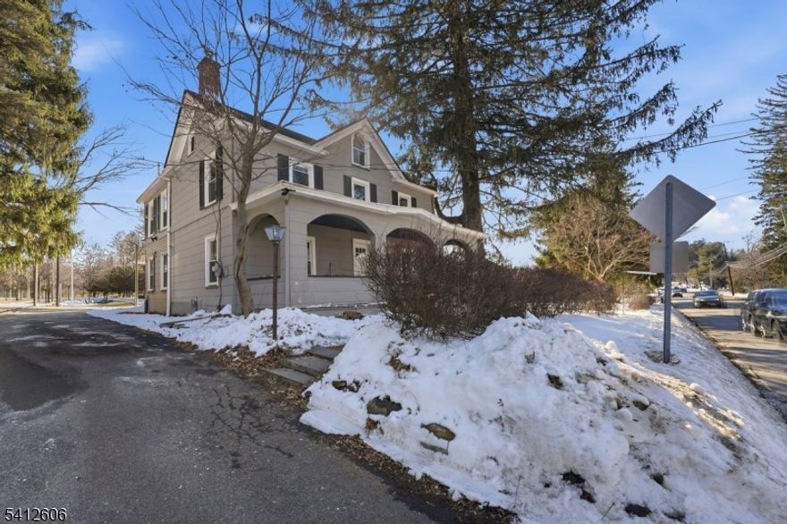 Wonderful opportunity to own this one of a kind Updated Classic Colonial set on pristine lot.  This home comes with the adjacent lot, with the opportunity to build another home of approx 4000 Sq Ft. Blending historic charm with thoughtful updates, this 4 bedroom, 2 full bath home features warm wood floors, exposed brick accents, and a wood burning stove that creates a warm and inviting atmosphere. The spacious living and dining areas are ideal for everyday living and entertaining, while the kitchen offers stainless steel appliances and ample cabinetry. An enclosed solarium provides additional flexible living space filled with natural light. The covered front porch with classic arch details enhances the home's timeless appeal. Outdoor highlights include a large patio, garden beds, and a private wooded setting. A detached 3 car garage and full unfinished basement offer added flexibility and storage. Conveniently located near parks, shopping, and transportation, this property offers character, space, and potential.