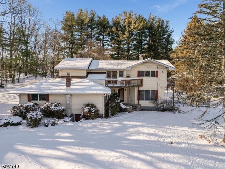 This property combines comfort, and functional living spaces in a serene outdoor setting. The open level lot offers a tree line view! An open floor plan is perfect for entertaining, with access to the pool area. First flour 'suite offers a  bedroom, living room, private kitchen, and bath with private entrance. The yard features decks, gardens, patios, and a shed. Gunite heated in ground pool with a built-in hot tub! The kitchen features granite countertops, large enter island, dual sinks, wood cabinets, new wall oven, and microwave. There are 3 decks- 1 off the upstairs loft. The primary bedroom overlooks the grounds from a private deck. Additional features include a relaxing soaking tub, stall shower, and ample closets space. Cozy up to the two fireplaces in the living room and a wood burning stove in the family room.