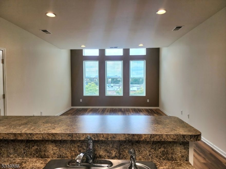 Step into this beautifully renovated, sun-drenched oversized 1-bedroom apartment perched on the top floor with sweeping views of vibrant and historic downtown Somerville. This spacious unit features soaring 9' ceilings, gleaming hardwood floors, central air, and in-unit washer/dryer for ultimate comfort and convenience. Enjoy exclusive off-street, assigned parking and access to a complimentary fitness room. A convenient elevator adds ease to your daily routine, and additional storage is available for a modest monthly fee. Live the charm of city life in prestigious Somerset County at a value that beats comparable rentals. Just steps from Zagat-rated restaurants, boutique shopping, and the world-class ShopRite. Premier retail destinations like Bridgewater Commons, The Promenade, and The Village are just minutes away. Commuting is a breeze with a NYC-bound train only one block away and quick access to Rt 22, 202/206, 78, and 287. Newark International Airport is just 35 minutes away.