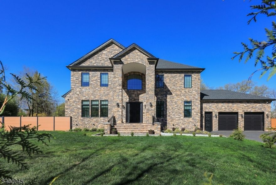 Exquisitely designed 5 BR, 4.5 Bath home boasts luxurious amenities throughout. Grand 2-story entryway welcomes you to the open floor plan living space that features a sun drenched living room which flows seamlessly into the dining room & kitchen area. Expansive gourmet kitchen features stainless steel appliances, convenient pot filler, hot water spout for sink, 2 dishwashers, 2 beverage coolers & massive walk-in butler's pantry. Spacious prep island, complete w/ wine fridge, countertop seating, storage cabinets and its own sink & dishwasher. Cozy up alongside the custom gas fireplace or watch the big game in the oversized family room that opens directly up to the kitchen. 1st floor bedroom features a full bath en-suite and can make the ideal guest room or home office. Primary bedroom retreat offers a lavish sanctuary to decompress with an oversized stand-up shower, dual sink vanity & towel warmer. Upper level laundry room provides an added ease to laundry duty. Spacious, multi-level wrap-around deck with multiple entry ways, granite for fire-pit, gas outlet for grill & wiring ready for outdoor speakers. Whole house filter & RO system for drinking water. Heated garage w/ electric car outlets & extra washer. Other features include built-in Kef speakers on the 1st floor & basement movie theater, Wifi enabled Sprinkler system, Wifi extenders for whole house, hard-wired exterior CCTV cameras & video doorbell. Stately elegance & refined craftsmanship found throughout the home