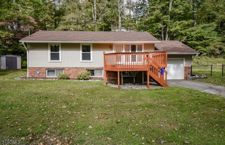 Move right in to this charming and spacious 3 bedroom raised ranch in desirable Paulinskill Lake.  This home shows pride of ownership inside and out.  Beautiful wood floors throughout and lots of windows for natural lighting.  Tons of cabinet space and room to work in the eat in kitchen.  Three generous sized bedrooms with large master with ensuite bath.  The finished basement is huge and features large laundry room and additional bonus room that could serve as a guest bedroom or office.  Attached garage for additional parking or storage.  Plenty of entertainment space outdoors as well with huge front and rear decks that have just been freshly painted, and a flat fenced yard round out this picture perfect home.  See it today!