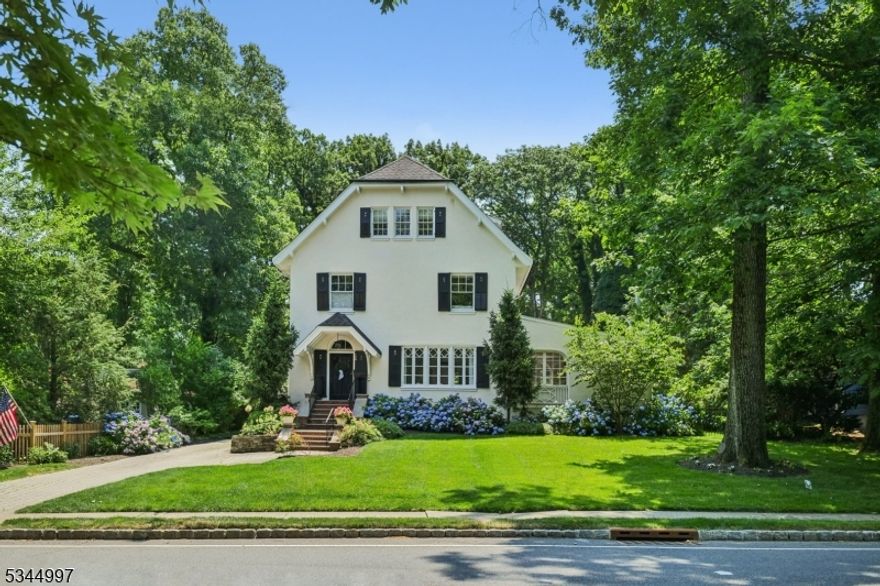 SUMMIT ENGLISH COLONIAL * AMAZING MEMORIAL FIELD LOCATION * A rare opportunity to acquire your dream home that has an easy-flowing floor plan, renovations on every level and blends beautiful traditional elements with modern, cosmopolitan appeal. Enter front-to-back foyer where the elegant living room, adjoining family room w/ fireplace and formal dining room with fireplace greet you. Toward the back find a built-in bar, powder room, mudroom with cubbies, access to the 2-car garage & the gourmet kitchen w/ breakfast rm & built-in desk. The state-of-the-art kitchen has stainless steel appliances (Viking/Bosch), center island w/ bar seating, quartz counters & backsplash and French doors to the lush, landscaped property--absolutely perfect for todays living! UPSTAIRS: 6BRs occupy 2nd&3rd levels, including the luxurious primary suite with a large WIC & gorgeous marble bath with double vanity & glass shower. LL: office/bonus rm with full bath, laundry rm, exercise space & rec rm. STEP OUTSIDE: French doors lead to the Bluestone patio which overlooks the professionally landscaped property with mature trees, perennial gardens & large lawns (room for pool). MORE: CAC, security system, Nest Thermostats, smart lighting, generator hook-up, high ceilings, diamond-paned windows & hardwood flrs. CLOSE TO EVERYTHING: downtown, top-rated schools (Brayton Elementary-0.3mi & SMS-0.5mi), Summit Art Center & Summit train station (0.8mi) for a quick commute to NYC. This magical home will not last!