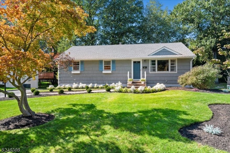 Lovely & Full of Recent Updates, this expanded ranch is conveniently located in a quiet residential neighborhood of River Vale minutes away from highways, stores, restaurants, parks, and top schools, just 20 miles away from NYC. Wonderful curb appeal leads you inside, where you'll find gleaming hardwood floors and recessed lighting in the spacious and sun-filled living room with open flow into a formal dining room. Just beyond is the kitchen equipped with classic white cabinetry, crisp white appliances, and breakfast bar with extra seating. You'll enjoy relaxing and entertaining in the inviting family room, which features a freestanding fireplace and big windows for ample natural light and views of the backyard. Wood floors continue into 3 bedrooms including a generous primary with ceiling fan and direct access to a beautiful full hall bath with storage vanity and tub/shower combo. A second full bath off the family room has a walk-in shower. The oversized and freshly painted 2-tier deck is awaiting your summertime cookouts and overlooks a sprawling and shady lawn with lots of room for gardening or playing games. A spacious extra storage room with access from the deck.  The unfinished basement houses laundry, utilities, storage space, and access to the attached rear-entry 1-car garage. Bathrooms renovated in 2023, this home also boasts a new roof (2021), new central air (2022), and updated front landscaping. This move-in ready gem leaves nothing to do but unpack and enjoy.
