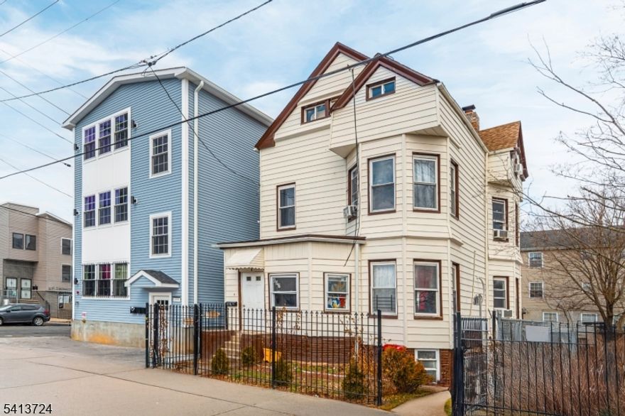 Check out your new home! This five-bedroom, two-bath home blends classic character with thoughtful updates across three finished levels, offering both flexibility and function. The first floor welcomes you with an enclosed front porch into entry foyer, to a large dining room and living room with high ceilings, large windows and plenty of natural light. A first floor laundry room/pantry adds everyday practicality. Continue into a spacious eat-in kitchen. Just off the kitchen, you'll find access to the yard. The second level offers three generous bedrooms and a full bath. A rear staircase provides direct access back to the kitchen a feature you don't see every day and one that adds convenience and flow. The finished walk-up attic expands the layout with two additional large bedrooms and another full bath, ideal for guests, work-from-home space. There is a full unfinished basement that includes a separate entrance, offering future potential depending on your needs. This home is situated on a quiet street steps to NJ Transit's Essex line and minutes to Route 280, Route 21, the Garden State Parkway and University Hospital. This home is a great choice for commuters who value accessibility, and need a lot of space.