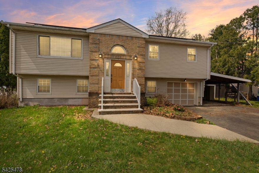 Step into this spacious corner lot bi-level home offering a total of 5 bedrooms and 2 full baths, 2 full kitchens. You can easily set up an in-law suite or a guest floor.  This whole property was thoughtfully designed for comfortable living and effortless entertaining. The upper level welcomes you with a bright entry foyer featuring a half-moon window, leading into an open-concept living/dining combo. The living area is accented by a sleek wall-mounted electric LED fireplace, while the adjoining dining space flows seamlessly into the updated maple kitchen, complete with eggshell Corian countertops, a mini subway tile backsplash, and a convenient spacious breakfast bar. Three generously sized bedrooms and a full bath complete this level. The lower level provides additional versatility with a second full kitchen and cozy breakfast nook, perfect for extended living or hosting. This space opens directly to a covered patio and swimming pool, and hot tub, creating a great setting for outdoor enjoyment. Two additional bedrooms, including a spacious primary bedroom with sliding glass doors to the patio, a full bath, and an oversized laundry room round out this level. With ample space and a flexible layout, this home offers a perfect blend of comfort and functionality.