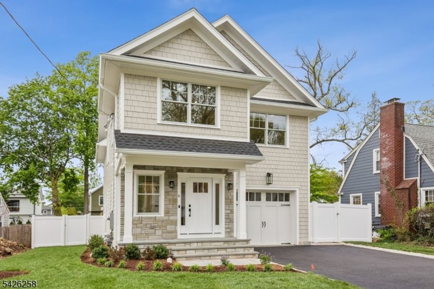 Experience exceptional craftsmanship in this new home built by a premier, quality driven builder known for creating multimillion-dollar residences in the area's most prestigious communities. Perfectly situated in Madison, this home seamlessly blends timeless design with modern luxury. Welcoming entryway sets the tone highlighted by custom trim & moldings, along with stunning white oak flooring. The thoughtfully designed open floor plan connects the elegant dining area to a chef's kitchen, complete with a striking center island , quartz countertops, custom handmade cabinetry by a local artisan, & top-of-the-line Thermador appliances. The spacious family room offers a gas fireplace & sliders that open to a patio & enclosed, professionally landscaped yard ideal for indoor-outdoor living. Additional main level highlights include a powder room, walk-in pantry, mudroom and direct access to the garage. Upstairs you will find 4 generously sized bedrooms, including luxurious primary suite with vaulted ceiling, spa like bath, 2 custom fitted walk-in closets. 2nd bedroom features its own ensuite bath, while 2 additional bedrooms share a beautifully appointed hall bath with double vanity. A convenient 2nd floor laundry room completes this level. The finished 3rd floor offers a bonus space perfect for home office, gym, or playroom. The finished basement features 5th bedroom, full bath, rec room with wet bar and storage. Exquisite trim, designer lighting & meticulous attention to detail.