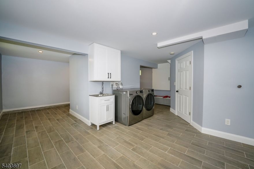 Beautifully renovated 3-bedroom, 2-bath colonial house in Totowa featuring a bright, spacious layout across three levels. Ground level offers flexible space ideal for a home office, gym, or recreation area with walk-out access. First floor includes a new kitchen with quartz countertops, stainless steel appliances, and soft-close cabinetry, along with a living room, full bath, and one bedroom. Second floor features two additional bedrooms and a full bath. Large yard with scenic views, perfect for outdoor enjoyment. Conveniently located near shopping, dining, parks, and public transportation. New electric, new plumbing, and one-zone central forced-air system. Washer and Dryer in unit. 2 car driveway. Fully renovated in 2022. VACANT, easy to show, and move-in ready. Now available for rent.