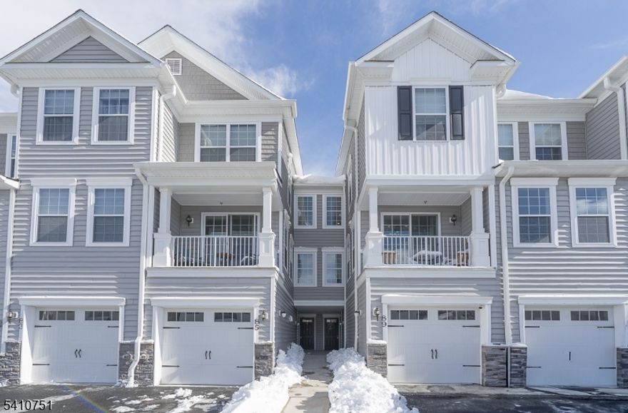Sunlight, space, and serene views define this Norfolk Walk-Out in prestigious Hilltop at Cedar Grove. Positioned on a premium lot, this 2020-built home offers three levels of refined living designed for comfort and connection. 9' ceilings with crown molding and two banks of oversized double-hung windows and glass-paneled door flood the open-concept layout with natural light. The chef's kitchen features a granite center island, custom cabinetry, pantry, and effortless flow into dining and living spaces anchored for everyday living and entertaining. Step onto your private deck for tranquil wooded views and peaceful mornings. Upstairs, the primary ensuite offers a serene retreat with glass-enclosed shower, double sinks and walk-in closet. Completing this floor is a spacious second bedroom, hall bath, and convenient laundry. The finished walk-out lower level expands the home's versatility with a generous living area, full bath, and bonus room ideal for a third bedroom-plus; convenient access to a covered patio & green space. Ample storage, custom California closets, one-car garage, driveway parking and tax abatement through 2030 complete the package. Enjoy resort-style amenities: infinity pool, hot tub, clubhouse, outdoor fireplace, grilling stations, fitness center, & miles of trails at Hilltop Reservation. Minutes to shopping & dining on Bloomfield Ave. & downtown Montclair, top-rated schools. Complimentary jitney service to Upper Montclair station w/ NYC Penn direct trains.