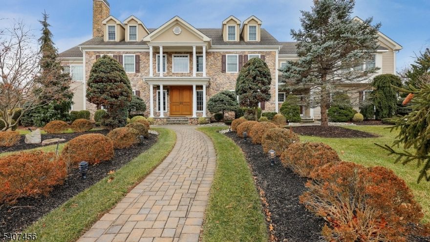 North Edison home nestled on a quiet cul-de-sac in this luxurious custom-built estate blends timeless craftsmanship with elegant design and exceptional functionality.  A striking stone facade creates unforgettable curb appeal, setting the tone for the sophistication found through the home. Step inside to a dramatic 2-story foyer showcasing a stunning starburst walnut inlay.  Rich hardwood floors flow throughout, complemented by crown molding, chair rail, and wainscoting, creating a refined yet welcoming atmosphere in every room.  A distinguished private library offers the perfect work-from-home retreat, complete with custom-built desks, cabinetry, shelving, and its own private exterior exit for added convenience and privacy.  Designed for both entertaining and everyday luxury, the gourmet kitchen is a chef's dream featuring an oversized center island, granite countertops, custom cabinetry, beverage cooler and not one - but 2 walk-in pantries, plus a fully equipped butler's pantry for seamless hosting.  The primary suite is a private sanctuary boasting a spacious sitting room and dual walk-in closets with extensive custom built-in shelving.  For recreation and leisure, the home delivers in style with a dedicated recreational room and a theatre room which is ideal for entertaining guests or relaxing at home.  Every detail of this exceptional residence has been thoughtfully designed to offer luxury, comfort, and functionality - all in a prestigious cul-de-sac setting.