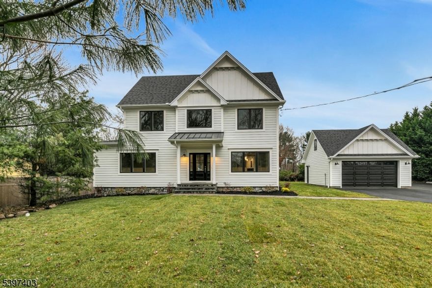 Welcome to this beautifully renovated 6-bedroom, 4.5-bath luxury home! Intricate custom millwork, high-end finishes and hardwood floors are found throughout every level of this exceptional home. The gourmet kitchen is a true showpiece boasting quartz countertops, custom tile backsplash, center island with seating, top-tier stainless steel appliances, extensive cabinetry and prep space, as well as a walk-in pantry with shelving and dry bar with a wine refrigerator. The family room features a gas fireplace flanked by built-in cabinetry and doors to the rear patio. Also on the first floor is the elegant living room, formal dining room, private en-suite bedroom (perfect as guest suite or office), mudroom, and powder room. Retreat upstairs to the luxurious primary suite with custom-fitted walk-in closet and en-suite bathroom with soaking tub, oversized glass-enclosed shower, and dual quartz vanities. 3 additional bedrooms (2 en-suite), and a laundry room complete this floor. Loft space on the 3rd level is ideal as a 6th bedroom with a large closet and extra attic storage. Fully finished basement is ready to customize to suit your needs. Enjoy outdoor living on the patio perfect for entertaining with views of the expansive property set on .74 acres. The detached 2-car garage is insulated with loft storage. Close to shopping, parks, restaurants, and transportation in a top NJ school district, this rare offering combines luxury, functionality, and privacy in one spectacular package!