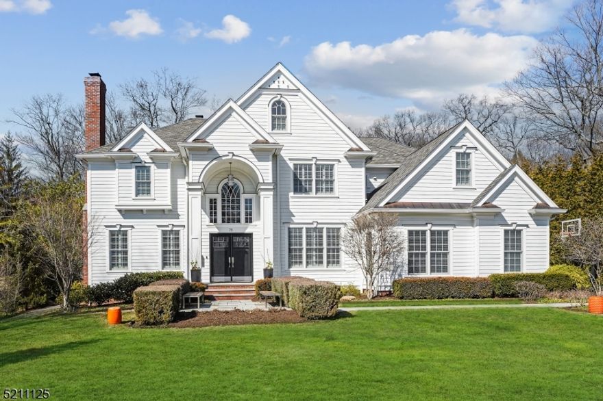 Sleek elegance and cool living are the hallmarks of this new Madison listing. Singular in style and dazzling upon entrance, this six-bedroom, six full and two half-bath home is located on a sought after street in the desirable "Hill" section of town. Illuminated by natural light, this West Coast inspired chic home is defined by its open spaces, clean lines and striking details. High ceilings, ebony-stained hardwood floors, contrasted by pure white walls and white custom cabinetry, are a dramatic canvas for the home's stylized moldings and appointments, creating an unparalleled aesthetic. Spacious rooms throughout maintain continuous style. With top-of-the-line appliances, surfaces, designer finishes, custom cabinetry and millwork, and extraordinary attention to detail, this captivating home is exception for living and entertaining. Exceptional 1+acre professionally landscaped property offers distinctive privacy, abundant spaces for entertaining and an expansive second tier lawn for playing. The backyard also boasts a limstone patio, lighted stone wall, built in limestone fireplace and built-in custom made firewood holder. Just 25 miles outside of Manhattan, accessed by NJ Transit's Midtown Direct, Madison strikes the perfect balance; convenient to the city and on the threshold of bucolic horse country. This charming town with top public and private schools, is an idyllic place to live.
