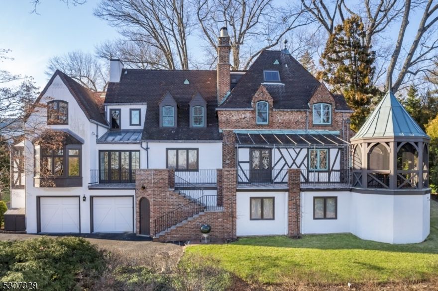 Nestled on Summit's North End, a head turning 4 Bedroom, 4.2 Bathroom, "Tudor-Style", one-of-a-kind house with incredible curb appeal on a serene street with no through-traffic. Ancient Highland manor house with cutting-edge modern design sits on 1.75 acres of private grounds with spectacular views of the NYC Skyline. New state-of-the-art custom Chef's Kitchen featuring Gaggenau appliances, Cesar cabinetry, waterfall Caesarstone ceramic countertop, and open Breakfast Area leading out to expansive Stone Terrace. Living Room with stately French fireplace and original mantle. Sunken Entry Foyer that "wows  with elegant Powder Room. Refreshed En-Suite Family Room with custom built-ins, large bay window with window seat, Full Bathroom and separate side-door entry. Second Level Primary Suite is its own wing with ample closets, hardwood floors, sunlight and a gorgeous Bathroom with large soaking tub. Refinished sunlit En-Suite 4th Bedroom on 3rd floor with charming sunken sitting area and Full Bath. Lower Level features a "Pub Style" Recreation Room, a custom Wine Cellar, a newly finished Laundry Room, and a large Gym. Featuring authentic custom heavy oak doors, original oak flooring, stained-glass windows, arched doorways, unique vaulted ceilings, and detailed plaster moldings throughout the entire home. Incredibly special opportunity for the discerning homeowner seeking the best schools, nearby NYC transportation, amazing eateries, shopping and more. 65 Edgewood will not last!