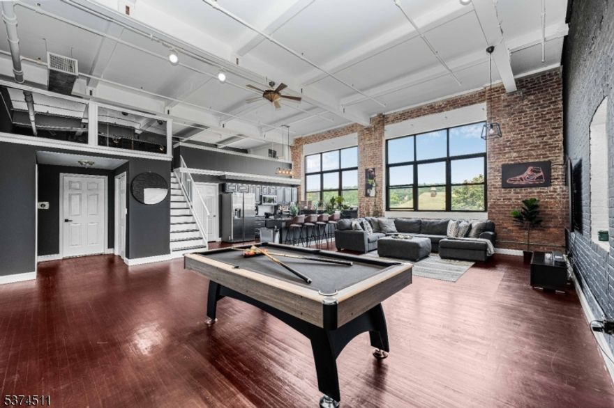 Welcome to Unit 204 at the Highland Lofts!.If you are a NYC commuter this is the PERFECT home for you with the train station to new york penn station being directly across the street! Recently updated in 2022 with a bathroom makeover and newer appliances. This generously sized 1700 plus sq ft loft styled Condo is unique & truly a hidden gem. Unit features Hardwood floors, 20 ft ceilings and large windows that brings in lots of natural light. Unit also comes with washer/dryer and  pool table, perfect for entertaining guests! Unit comes with one assigned parking space. Building features a recently renovated rooftop deck for your enjoyment! Come make this your next home!