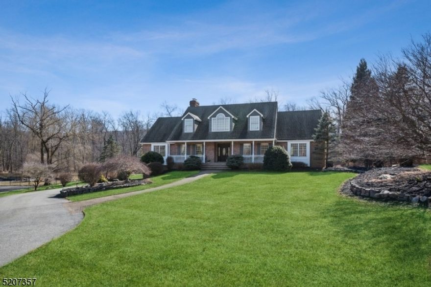 Picturesque private retreat surrounded by natural beauty!Spacious & spotless Center Hall Colonial is nestled on 1.5 flat, park-like acres on a quiet cul-de-sac in Kinnelon. This stately residence features beautifully scaled rooms, generous light, exquisite architectural details & sweeping views over expansive lawns & woods. A stone paver walkway & a covered front porch guide you inside to a 2-story foyer with a graceful quarter-turn staircase. Warm hardwood floors gleam across the first floor living room with a vaulted ceilings, fireplace & the formal dining room with an elegant chair rail, parquet floors & crown molding. The light-filled eat-in kitchen features granite counters, rich wood cabinetry & a breakfast nook with sliding glass doors to the deck, the perfect setting for entertaining & sunset cocktails overlooking the private property. The layout continues with a large library/office, a family room, a powder room & laundry room. The first-floor primary bedroom suite includes two WIC & a lavish en-suite bathroom with a jetted tub & oversized glass shower. Upstairs are 3 additional bedrooms, a bonus room that could be used as a den/guest room & a full hall bathroom, while the fully finished walkout basement has a spacious recreation room, full bathroom, ample storage & access to the attached garage. Along with the option to join some of the close by lakes & just minutes to Pyramid Mountain Park, this home is near top-rated schools, RT 23 & I-287, stores & restaurants.